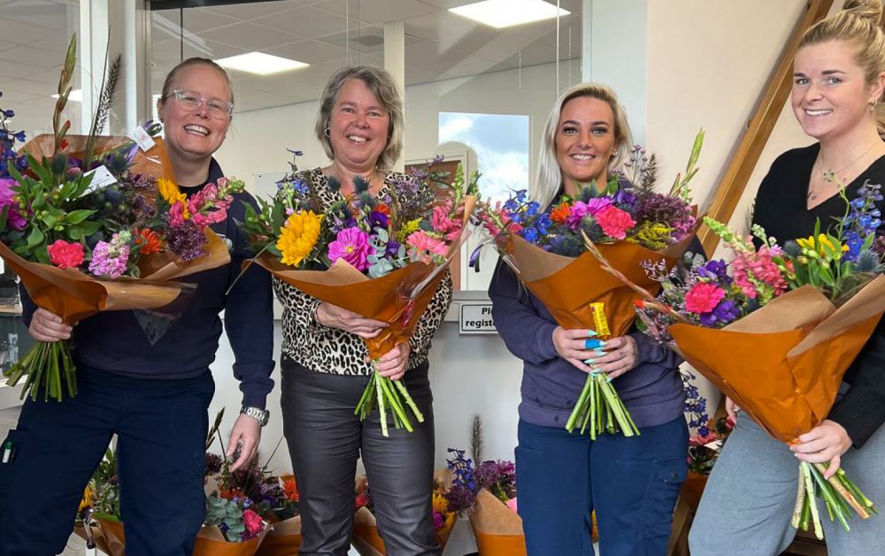 Four of our Intracare women posing with bouquets of flowers received for National Secretary's Day